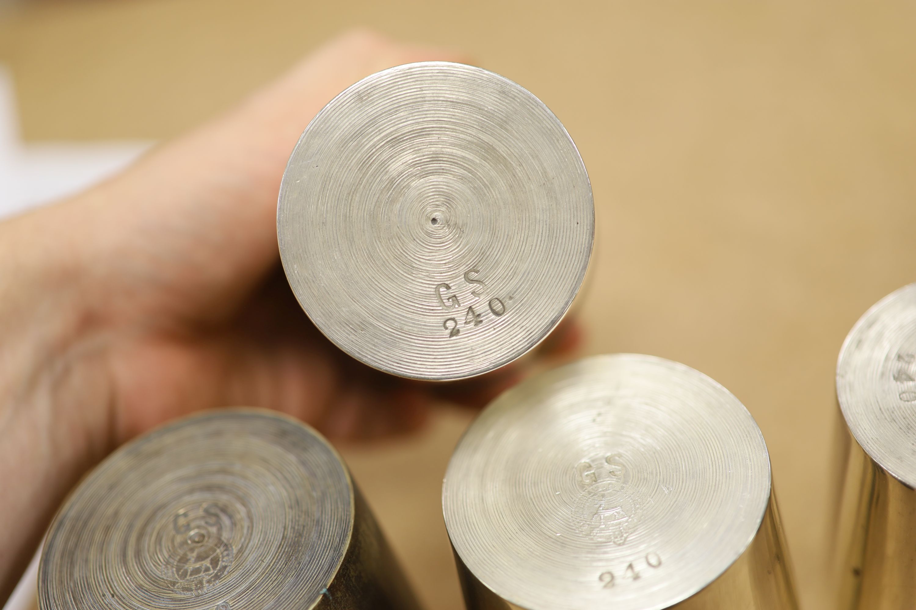 A leather cased flask and cups, various WWI and WWII medals, binoculars and a fishing reel